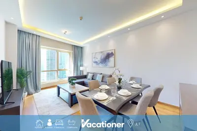 a living room with a table and a couch at Vacationer l Glamorous 2 Bedroom l Stunning Lake View l Free Wi-Fi in Dubai
