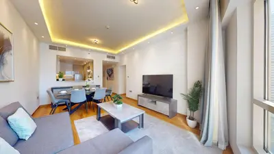 a living room with a couch and a table at Vacationer l Glamorous 2 Bedroom l Stunning Lake View l Free Wi-Fi in Dubai