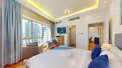 a bedroom with a white bed and a large window at Vacationer l Glamorous 2 Bedroom l Stunning Lake View l Free Wi-Fi in Dubai