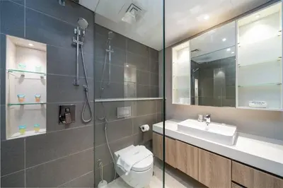 a bathroom with a shower and a toilet and a sink at Waterfront Living Bright 1 Bedroom Marina in Dubai