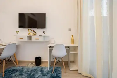 a room with two chairs and a desk with a tv at Ramora Homes Azizi Riviera 40 by Vacay Xeal in Dubai