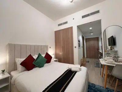 a bedroom with a large bed and a bathroom at Ramora Homes Azizi Riviera 40 by Vacay Xeal in Dubai