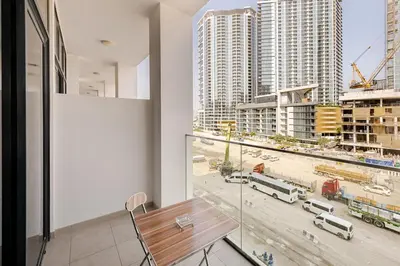 a balcony with a table and a view of a city at Ramora Homes Azizi Riviera 40 by Vacay Xeal in Dubai