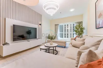 a living room with a large flat screen tv at Sky-Level 2BR with Partial Marina View, Just Steps to Dubai Tram and Minutes from the Beach, Elite Residence, Dubai Marina by Deluxe Holiday Homes in Dubai