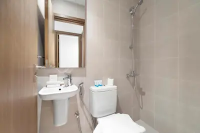 a bathroom with a toilet and a sink and a shower at 2BR with M CF7B Partial Canal View in Dubai