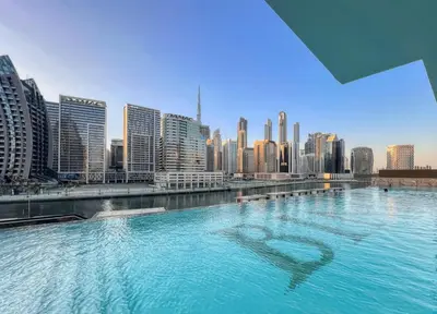 a swimming pool with a heart in the middle of a city at AWS Holiday Homes - Iconic Burj Khalifa Views in Dubai