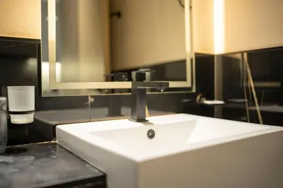 a bathroom with a white sink and a mirror at AWS Holiday Homes - Iconic Burj Khalifa Views in Dubai