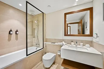 a bathroom with a sink and a toilet and a mirror at Private Beach , Luxury 2BR , Emaar 5-Star Amenities in Dubai