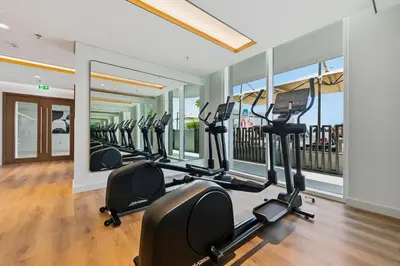 a gym with rows of treadmills and exercise bikes at Private Beach , Luxury 2BR , Emaar 5-Star Amenities in Dubai