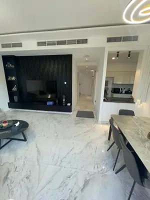 a large living room with a table and a kitchen at Dubai Hills Mahek Holiday Villa in Dubai