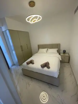 a bedroom with a bed with two shoes on it at Dubai Hills Mahek Holiday Villa in Dubai