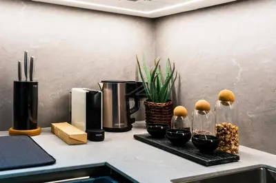 a kitchen counter with a coffee maker and fruit in vases at Exclusive 2BD in JBR Address with Ain Dubai View in Dubai