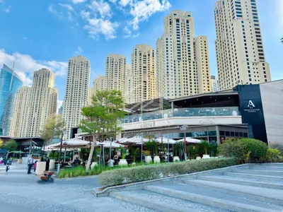 a building with umbrellas in front of a city at Exclusive 2BD in JBR Address with Ain Dubai View in Dubai