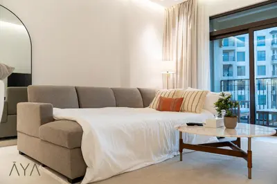 a living room with a couch and a table at Chic 1BR Apartment near Madinat Jumeirah BurjAlArab in Dubai