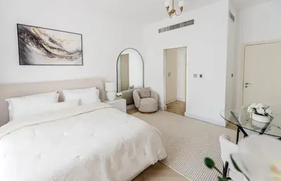 a white bedroom with a bed and a glass table at Spacious and luxurious studio with amazing marina view!Rimal ! in Dubai