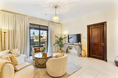 a living room with a couch and a table at 2BHK Downtown Breathtaking Burj Khalifa View in Dubai