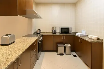 a kitchen with a sink and a microwave at The Rosewood HH at Sarai Residence, Palm Jumeirah, 5 mins from the Iconic Atlantis The Royale in Dubai