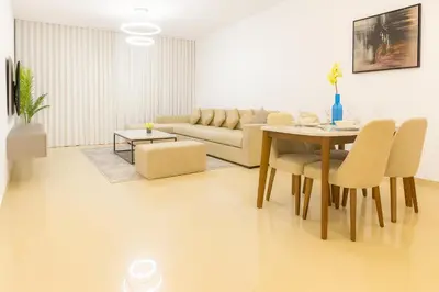 a living room with a table and a couch at The Rosewood HH at Sarai Residence, Palm Jumeirah, 5 mins from the Iconic Atlantis The Royale in Dubai