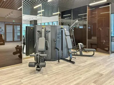 a gym with chairs and machines in a room at 2BR with M CF7B Pet Friendly Stay in Dubai