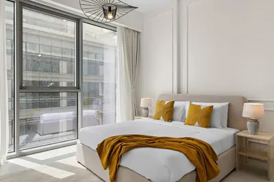 a bedroom with a large bed and a large window at 2BR with M CF7B Pet Friendly Stay in Dubai