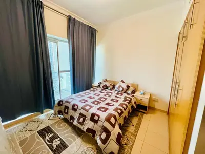 a bedroom with a bed and a window at Bussinss bay in Dubai