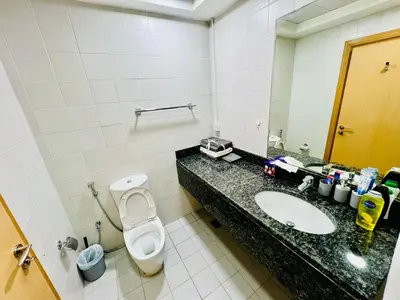 a bathroom with a sink and a toilet and a mirror at Bussinss bay in Dubai