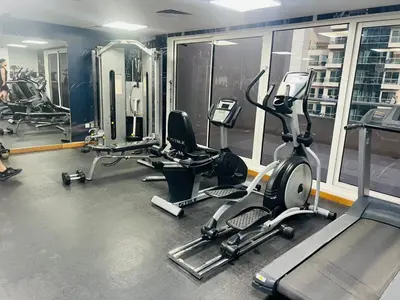 a gym with several treadmills and cardio machines at Bussinss bay in Dubai
