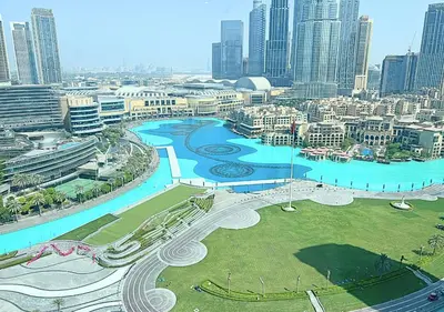 an aerial view of a city with a river at DreamShoma Grande Signature Luxury Full Burj Khalifa & Fountain View in Dubai