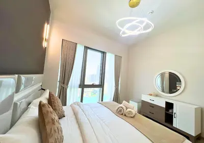 a bedroom with a large white bed with a mirror at DreamShoma Grande Signature Luxury Full Burj Khalifa & Fountain View in Dubai