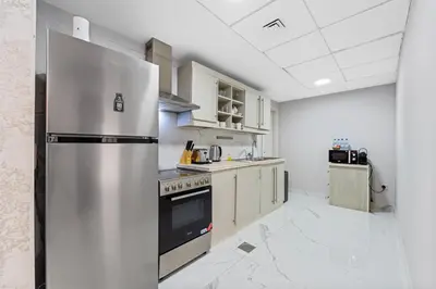 a kitchen with a stainless steel refrigerator at Duplex 2BR next to Marina Beach in Dubai