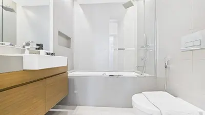 a white bathroom with a toilet and a sink at City Walk Building 16, Al Wasl, Jumeirah - Mint Stay in Dubai
