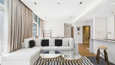 a white living room with a white couch and tables at City Walk Building 16, Al Wasl, Jumeirah - Mint Stay in Dubai