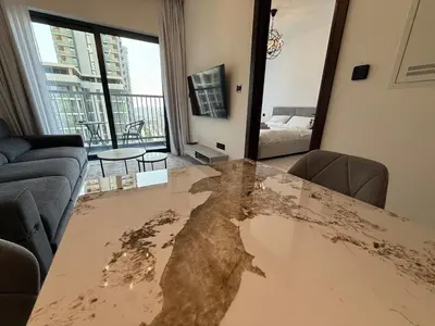 a living room with a table with a largeuddle of mud on it at Elegant 1-Bedroom The Crest, Near Downtown Dubai in Dubai