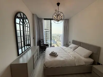 a bedroom with a large bed with a large window at Elegant 1-Bedroom The Crest, Near Downtown Dubai in Dubai