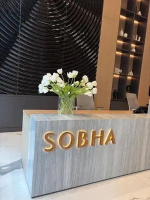 a vase of flowers sitting on top of a counter at Elegant 1-Bedroom The Crest, Near Downtown Dubai in Dubai