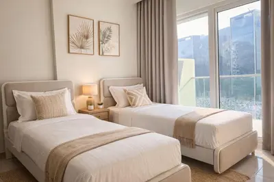 two beds in a hotel room with a window at Family Stay in Downtown 2BR Sleeps 6 Burj View in Dubai