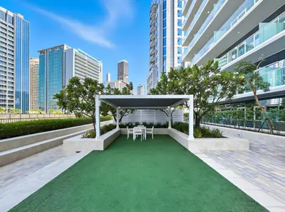 a gazebo with two chairs and a green lawn at Family Stay in Downtown 2BR Sleeps 6 Burj View in Dubai