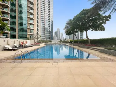 a swimming pool in a city with tall buildings at FIRST CLASS 1BR Central Dubai Luxury Living in Dubai