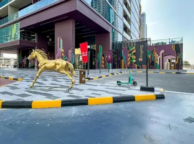 a statue of a horse running in front of a building at FIRST CLASS 3BR Elegant Comfort , Lake Views in Dubai