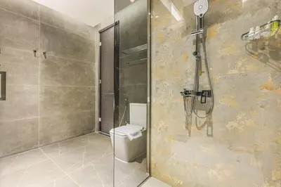 a bathroom with a shower and a toilet at FIRST CLASS 3BR Elegant Comfort , Lake Views in Dubai