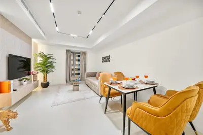 a living room with a couch and a table and chairs at FIRST CLASS 2BR Luxury Marina Bliss in Dubai