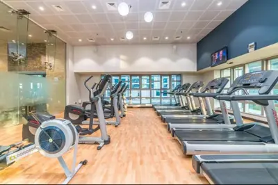 a gym with treadmills and elliptical machines at FIRST CLASS 2BR Luxury Marina Bliss in Dubai