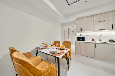 a kitchen and dining room with a table and chairs at FIRST CLASS 2BR Luxury Marina Bliss in Dubai