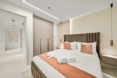a bedroom with a large bed with two towels on it at FIRST CLASS 2BR Luxury Marina Bliss in Dubai