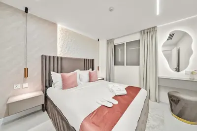 a bedroom with a large bed and a chair at FIRST CLASS 2BR Luxury Marina Bliss in Dubai