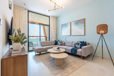 a living room with a couch and a table at Spacious Balcony with Breathtaking Creek Views, Just a Short Drive from Zabeel Stadium, Al Jaddaf Walk, and Cactus Park, Binghatti Avenue, Al Jaddaf by Deluxe Holiday Homes in Dubai