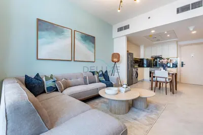 a living room with a couch and a table at Spacious Balcony with Breathtaking Creek Views, Just a Short Drive from Zabeel Stadium, Al Jaddaf Walk, and Cactus Park, Binghatti Avenue, Al Jaddaf by Deluxe Holiday Homes in Dubai