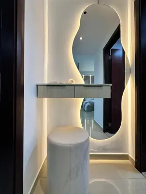 a room with a table and a stool and a mirror at Minimalist Studio with Amazings Marina Canal Views in Dubai