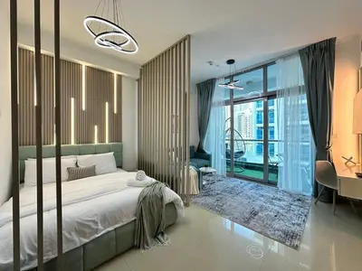 a bedroom with a bed and a large window at Minimalist Studio with Amazings Marina Canal Views in Dubai