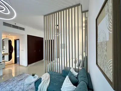 a living room with a blue couch and a table at Minimalist Studio with Amazings Marina Canal Views in Dubai